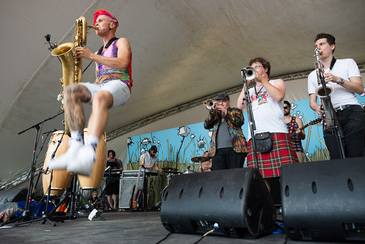 Leo Pellegrino of Too Many Zooz brings his performance from the New York City subways to the festival stage as he leaps into the air while never missing a beat on his baritone saxophone. The horn section from Five Alarm Funk lays a solid foundation for his solo.