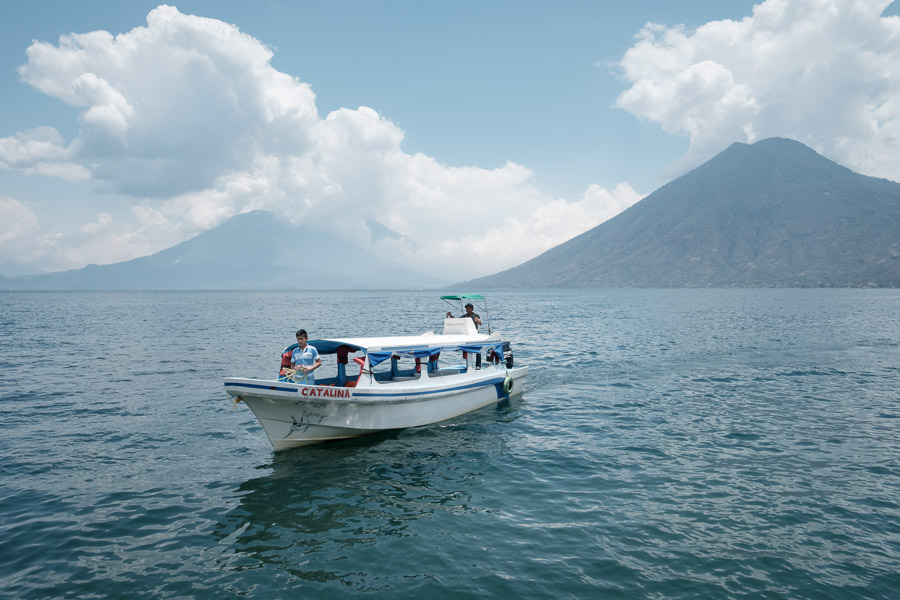 A typical public boat - known as a lancha - approaches a dock to shuttle people and cargo along the lakeshore. Its load is unusually light on this particular arrival.