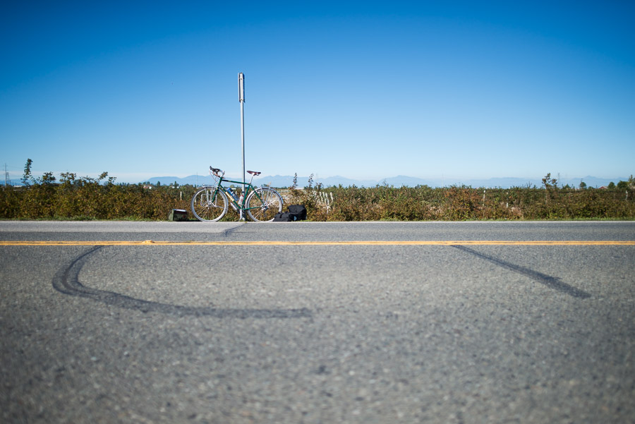 Waiting at a bus stop in the middle of absolute nowhere, because there weren&rsquo;t enough bike carriers on the last two buses at the ferry terminal to accommodate all the cyclists. I gave up my spot in line so that a couple could travel together, and was now wondering if that was the wisest choice. Improvising, I had arrived at this remote bus stop here trying to find an alternative route back to Vancouver and the train that would ultimately take me back to Winnipeg. After an hour sitting on the side of the road, there was still no bus to help me get through the tunnel.