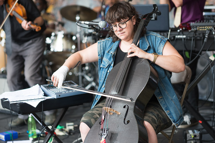 Cris Derksen plays her cello with mastery; the only indication of the cast on her right hand being the story she shared. A couple of days earlier, she was walking from her hotel and exploring downtown Winnipeg. Holding her phone out in front of her as a compass to help her get her bearings, a large piece of metal suddenly fell from the sky and hit her outstretched hand. The wind had knocked it loose from a construction site 23 floors up and she was lucky it did not end up worse. For that, and her dedication to her music, we are all grateful.