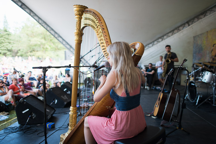 The crowd goes silent to listen to Mikaela Davis’ ethereal harp song.