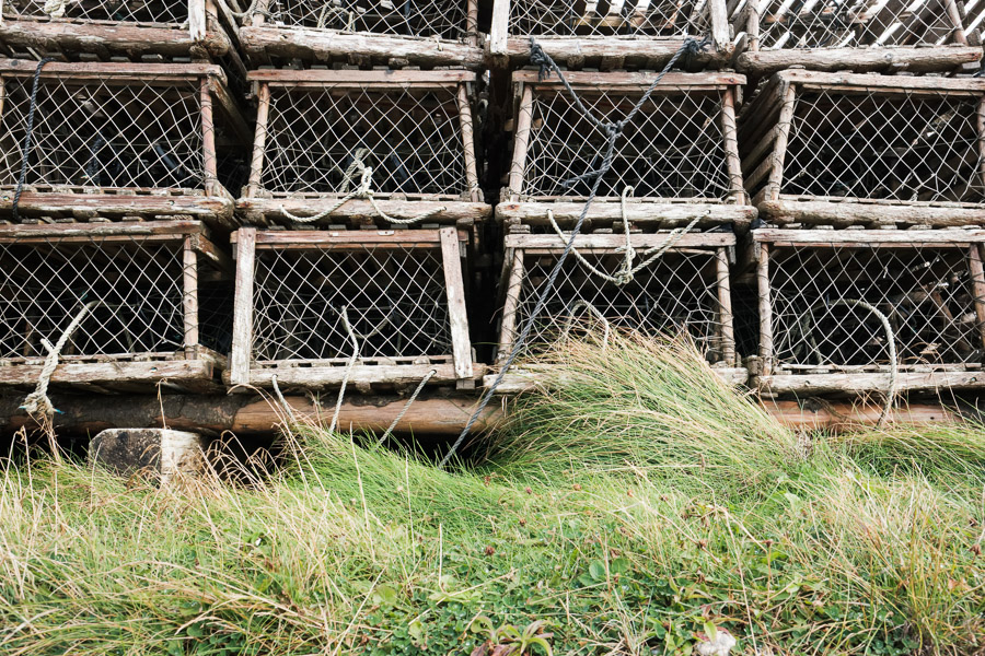 Lobster traps sit on the shore waiting for their season.