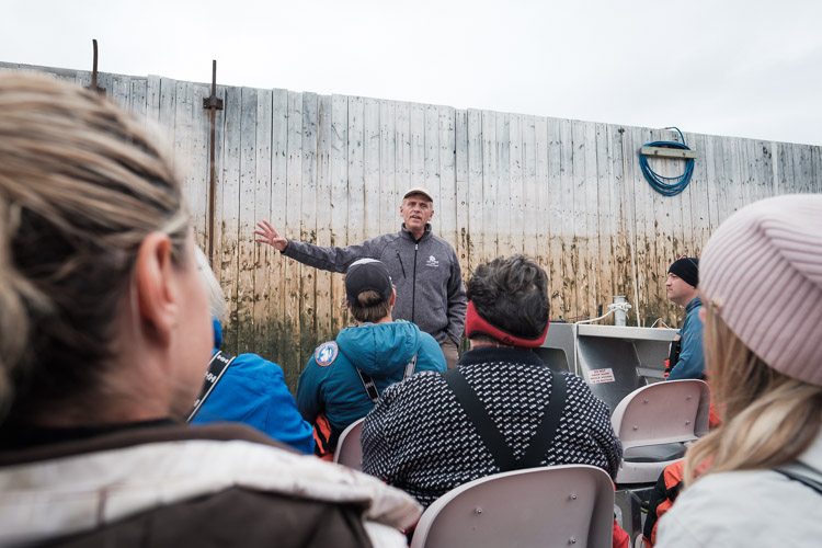 Wally Daudrich - the founder and owner of Lazy Bear Lodge and Expeditions - preps a group with boat safety necessities before they head out onto the rough waters of the Hudson Bay.