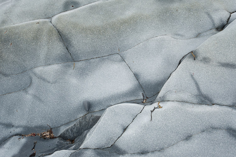 Exposed granite is incredibly smooth, scraped by the slow but forceful movement of ancient glaciers. Now that the great mass of ice has melted and is no longer weighing upon them, this bedrock is in fact rising in a process know as isostatic rebound (which amounts to it gaining a little more than one meter of elevation every year). This rock is part of the far-reaching Canadian Shield, and in this specific region it is known as Churchill Quartzite.